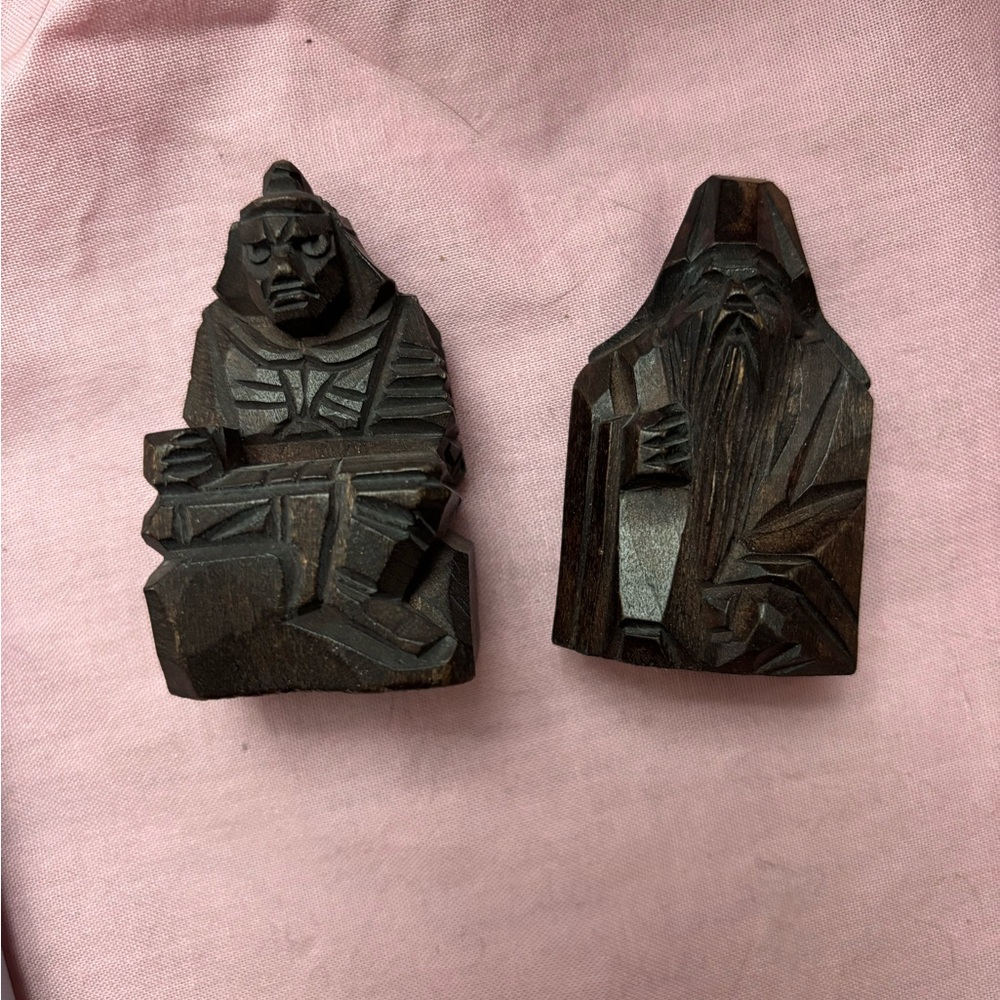 2 hand-carved mini wooden Chinese figures from their history.